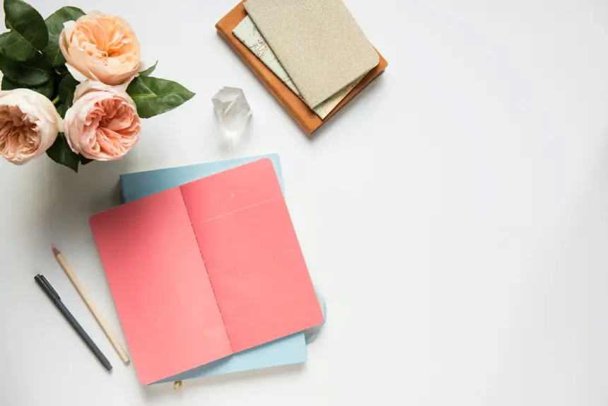 a pink journal and flowers